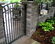 Ornamental aluminum, wrought iron arched gate by Elyria Fence