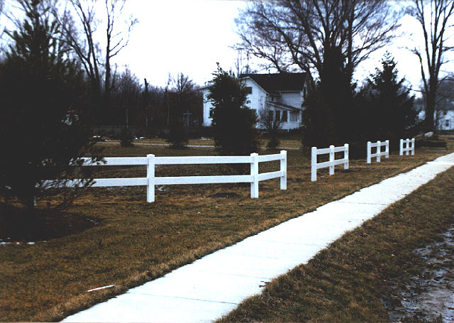 Vinyl 2 rail paddock rail fence by Elyria Fence