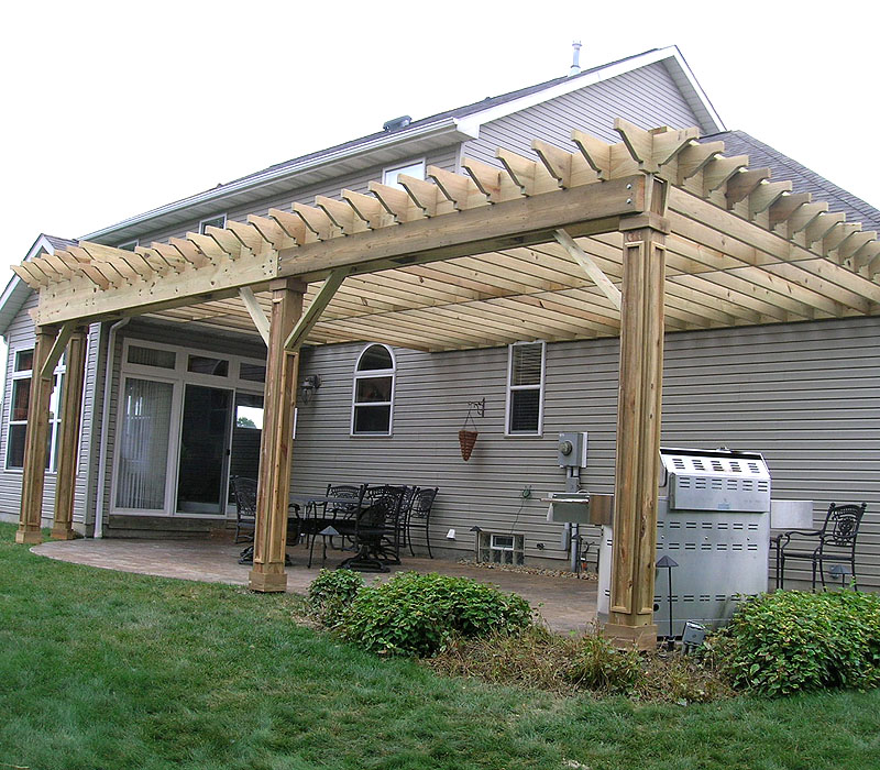 wood pergola with custom molding on the posts by Elyria Fence