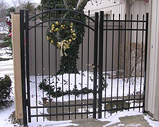 Ornamental aluminum, wrought iron arched gate by Elyria Fence