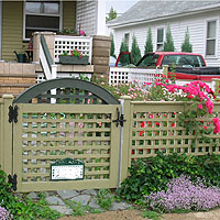 square lattice wood fence with arched square lattice gate by Elyria Fence