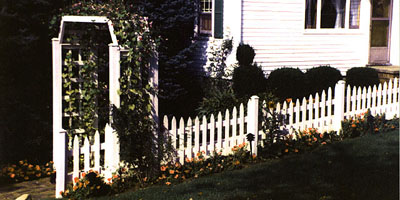 classic picket fence and arbor design by Elyria Fence