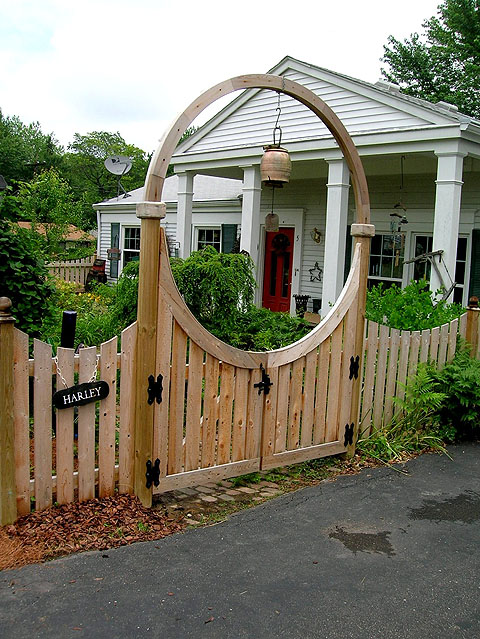 Wooden Halo Arching over a double gate by Elyria Fence Inc.