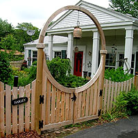Wooden Halo over a double gate by Elyria Fence