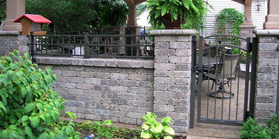 Ornamental Aluminum decorative fencing on a wall with an arched gate by Elyria Fence Company