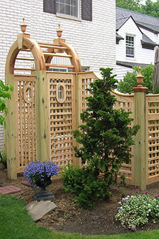 wood arched lattice fence with portholes by Elyria Fence